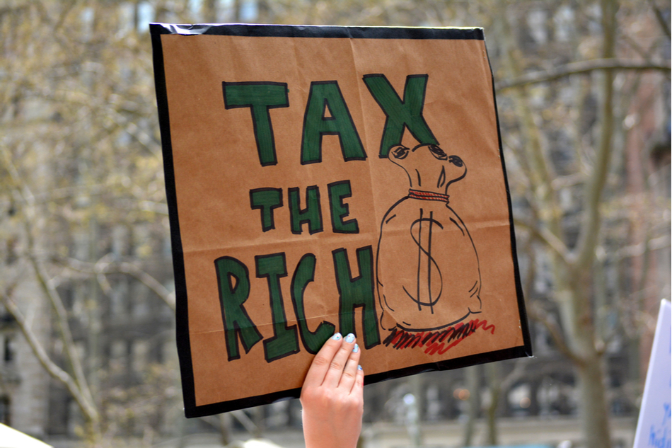 sign reads tax the rich