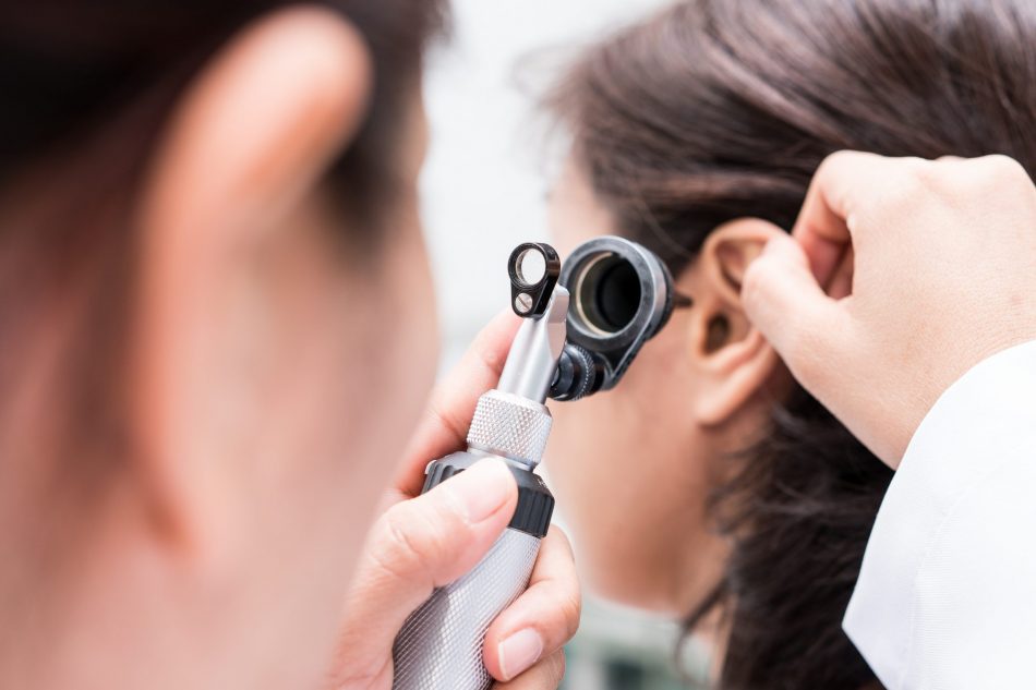 Doctor examined the patient's ear with otoscope.