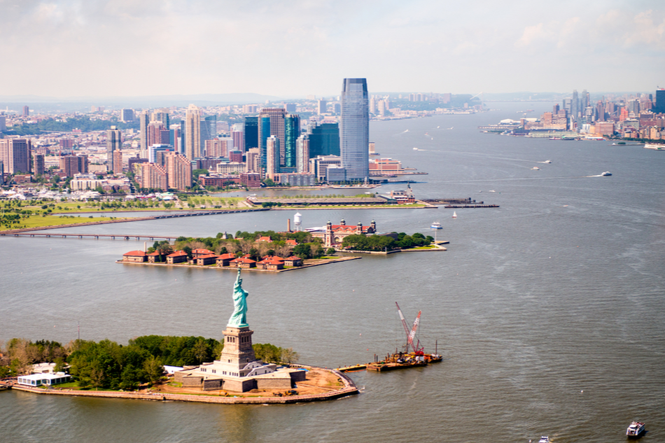 Statue of Liberty aerial view with Jersey City in the background.